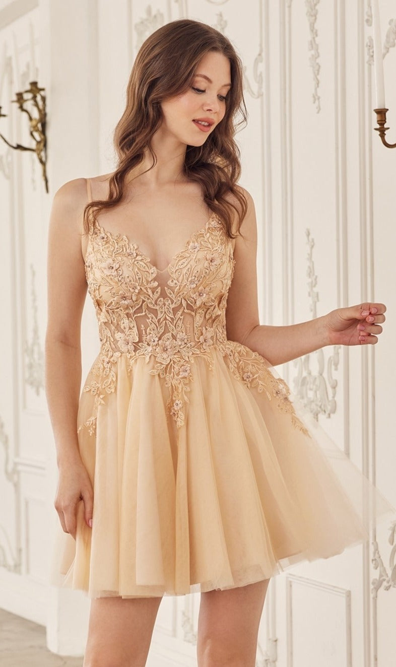 A woman in the Short Babydoll Homecoming Dress: CLSF047, featuring a light peach, sleeveless, knee-length A-line silhouette with an embroidered lace bodice, stands in an ornate room with white walls and decorative molding.